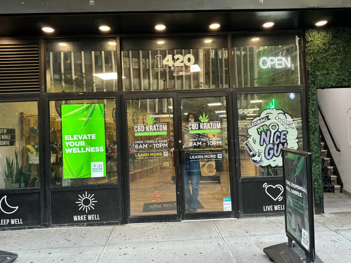 CBD Kratom storefront with a bright portrait window display visible from the street