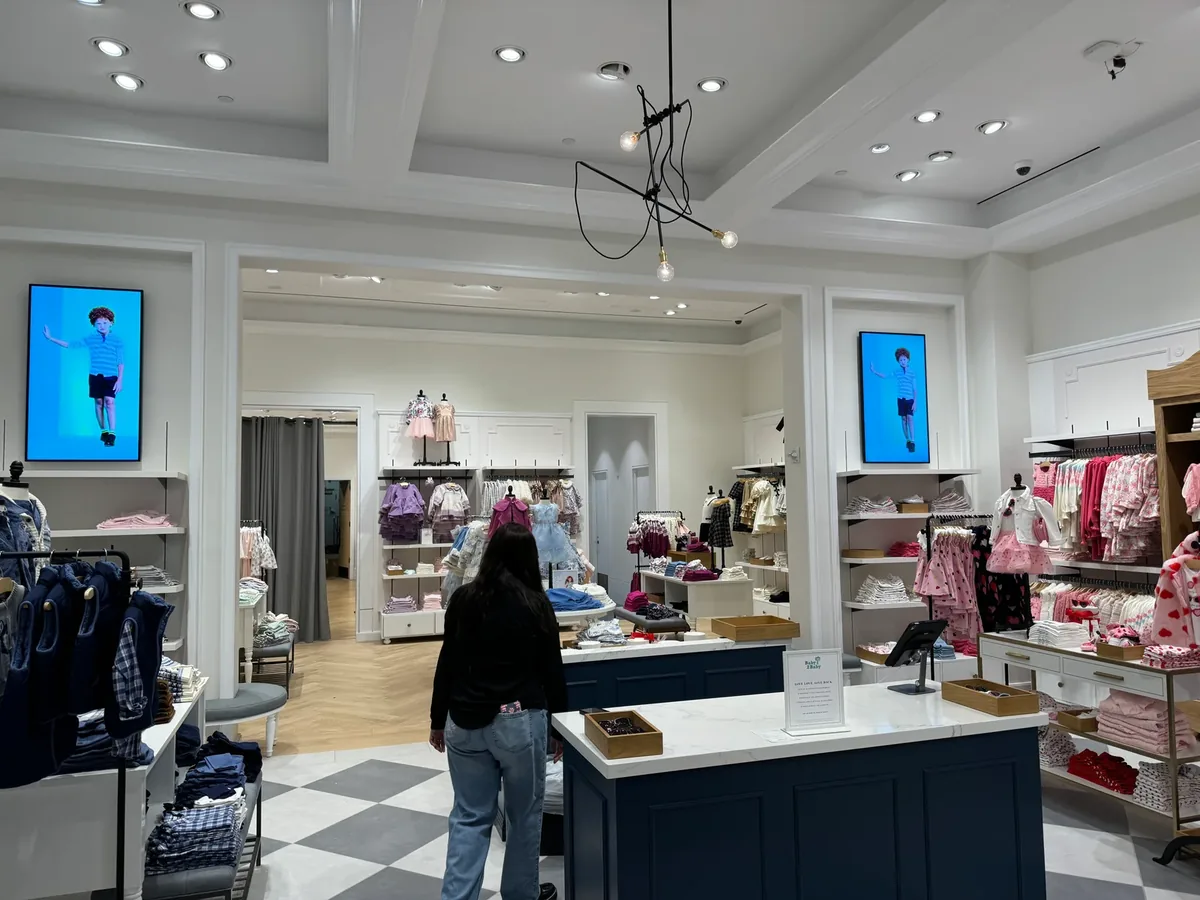 Janie and Jack store interior with portrait displays mounted high on two walls