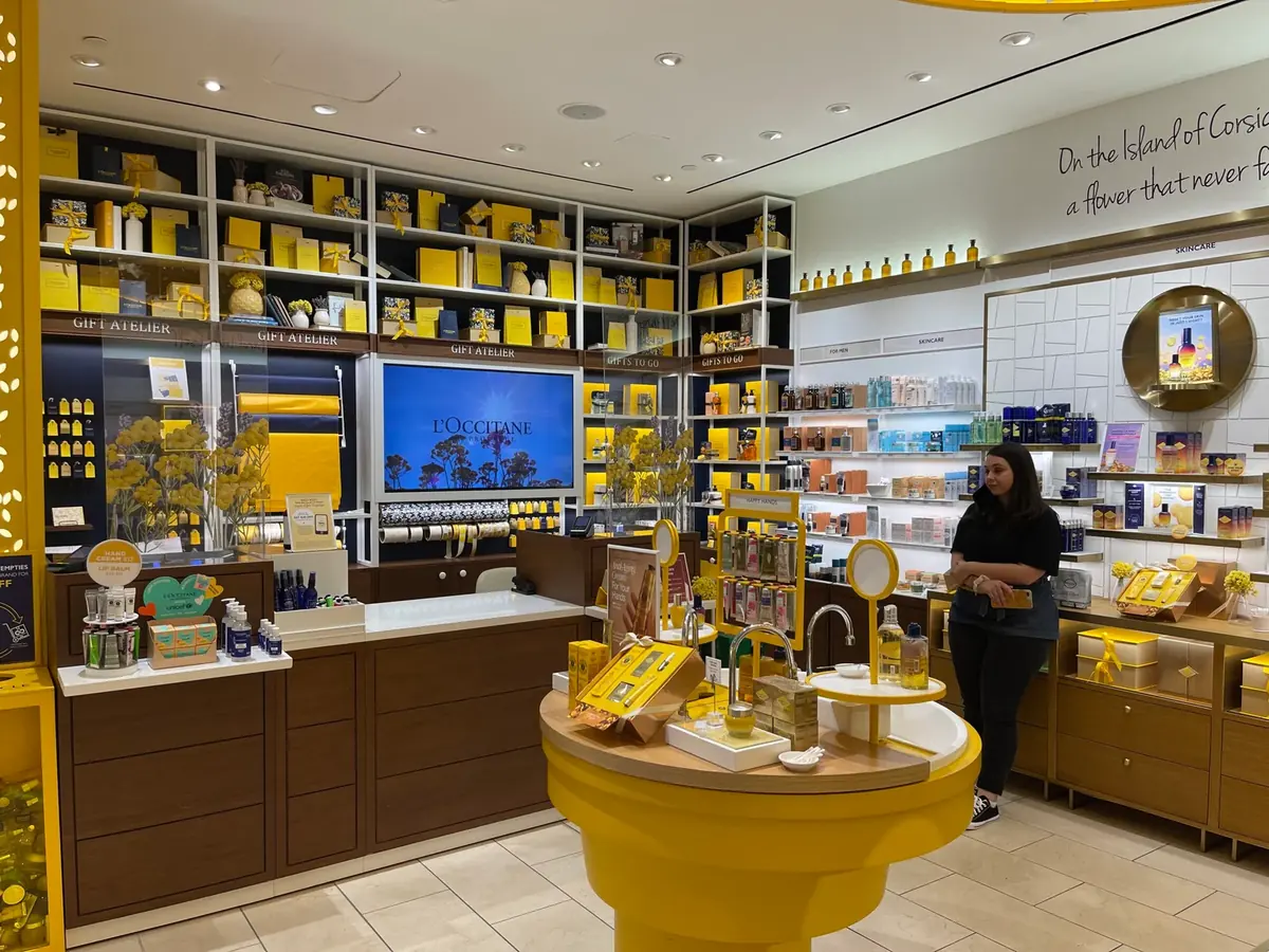 L'Occitane boutique cash wrap with an in-store display behind the counter
