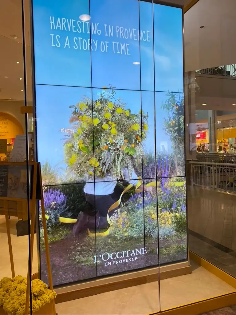 Tall portrait video wall in an L'Occitane storefront window