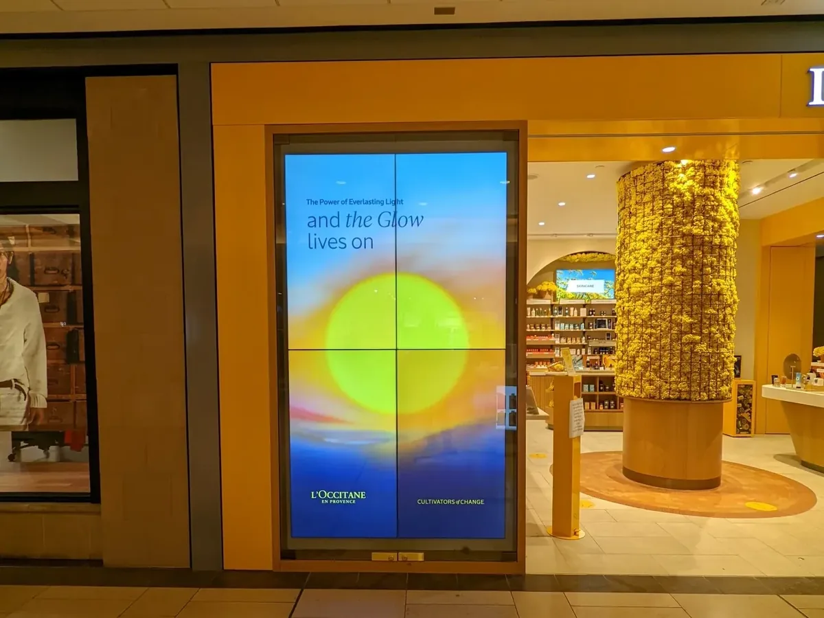 L'Occitane storefront with a portrait 2x2 video wall at the entrance