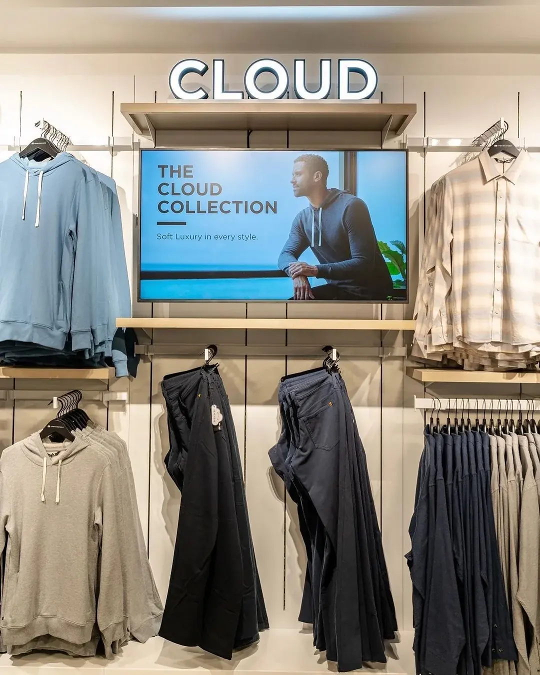 TravisMathew store with a display above a hanging apparel wall